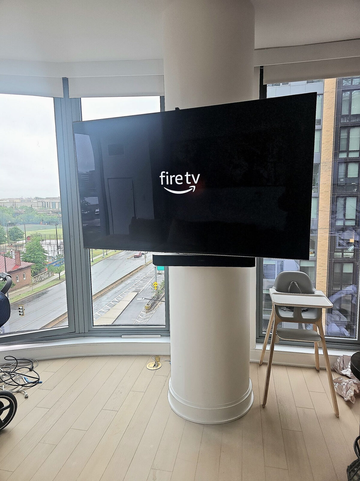 TV mounted to a round column in a high-rise apartment