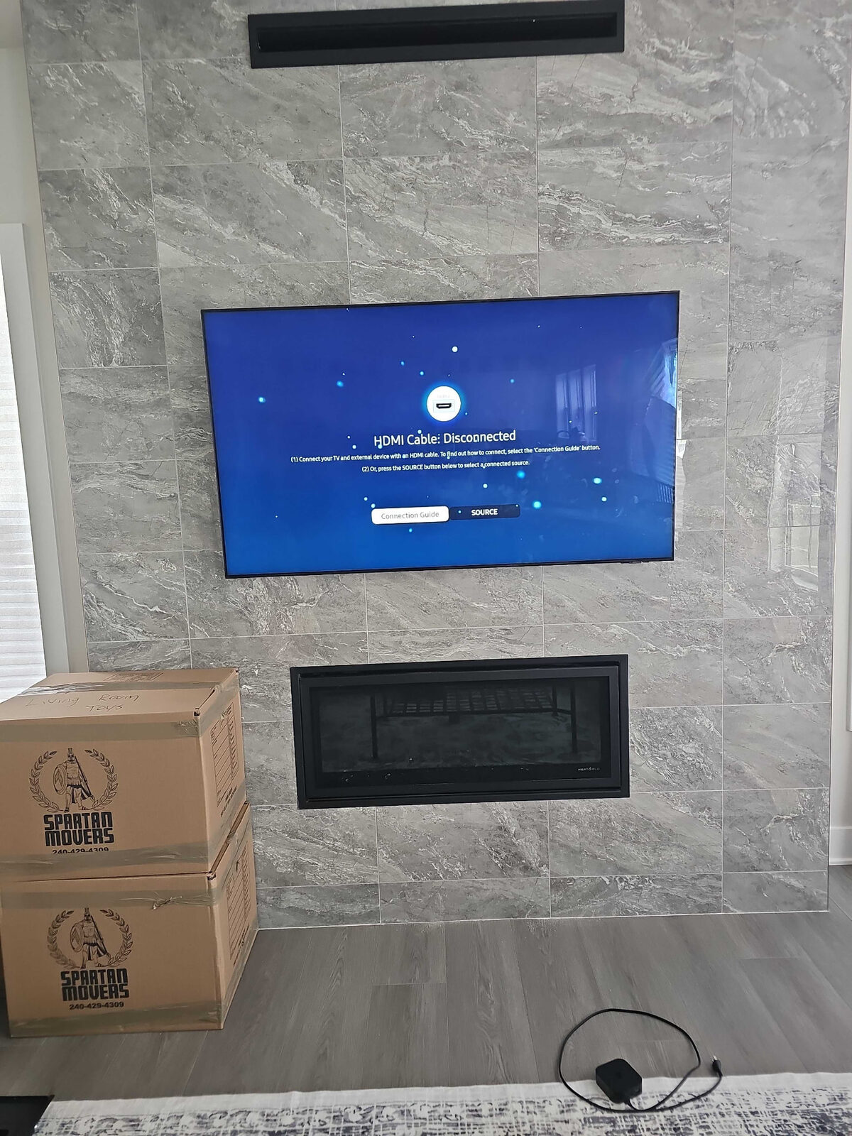 TV mounted above a fireplace on a tiled stone wall