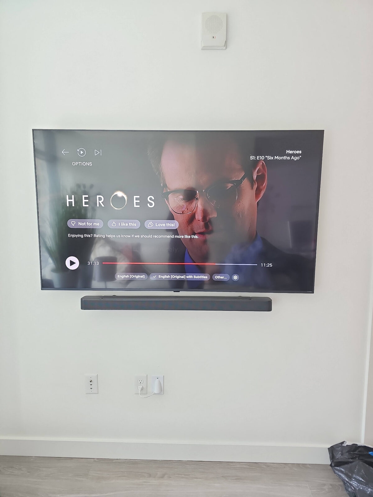 Samsung TV with soundbar wall-mounted in a living room